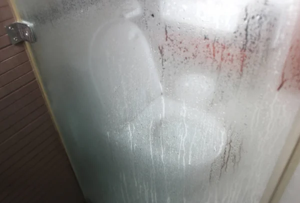 water closet in bathroom with steam droplet