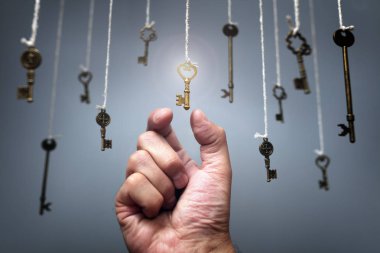 Choosing the key to success from hanging keys concept clipart