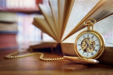 Pocket watch in library or study clipart