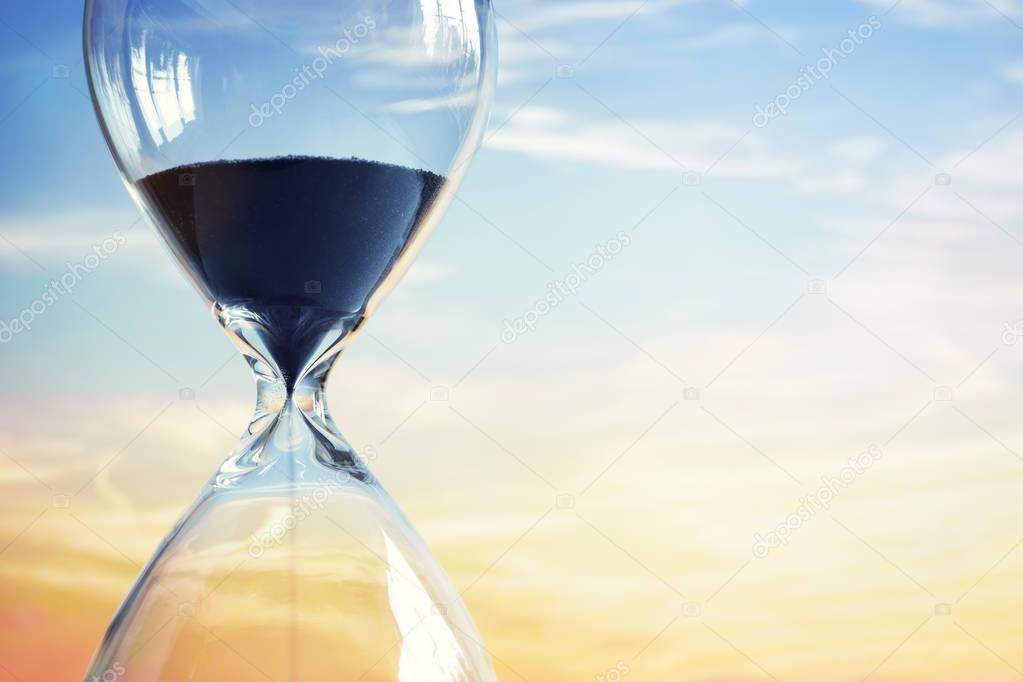 Hourglass at sunset with copy space