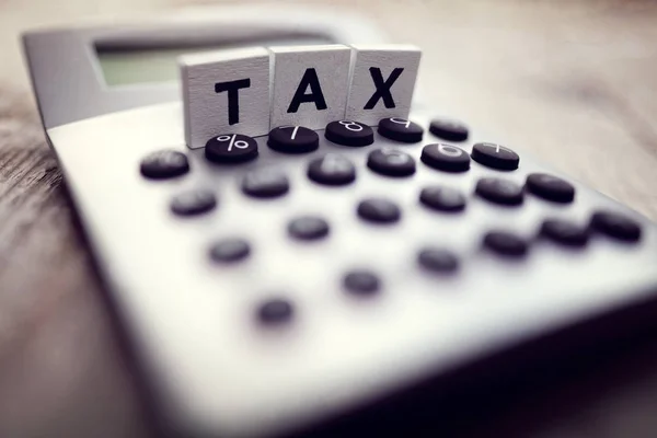 Calculator with the word tax — Stock Photo, Image
