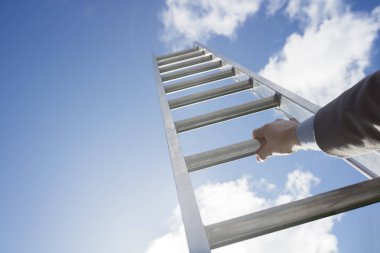 Businessman climbing Ladder of success clipart