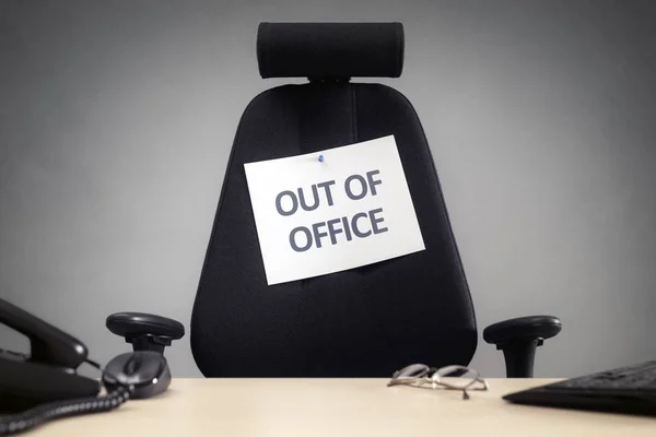 Företag stol med ur office sign — Stockfoto