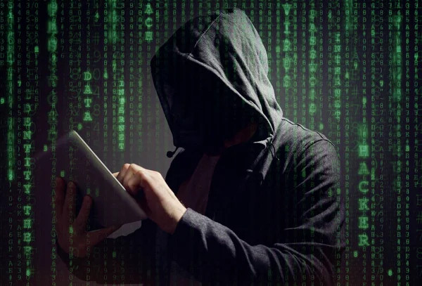 Computer hacker with digital tablet — Stock Photo, Image