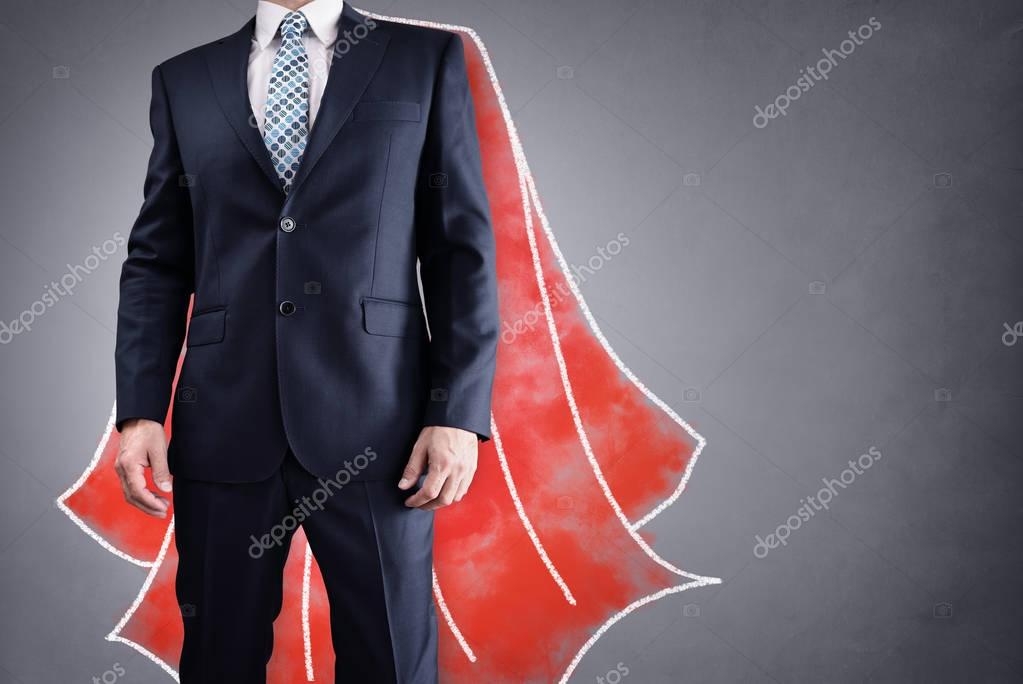 Superhero businessman with red cape drawing on background concept for leadership