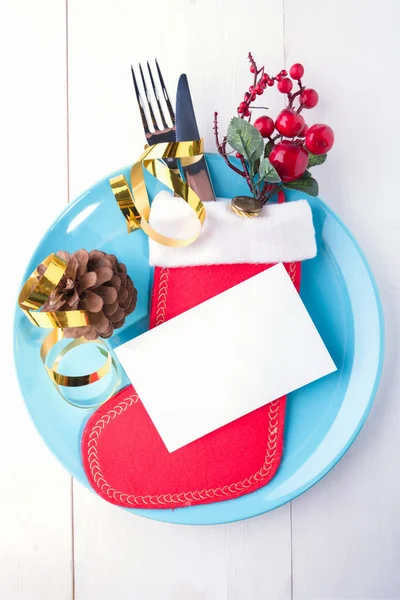 Festive place setting with christmas stockingTable setting with mock up invitation or place card for celebration Christmas and New Year — Stock Photo, Image