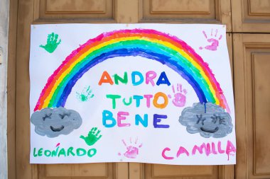 Avetrana, Italy, - Marth, 13, 2020. children's drawing on the door outside, children draw the rainbow with the Italian writing: everything will be fine. Italian flash mob against coronavirus