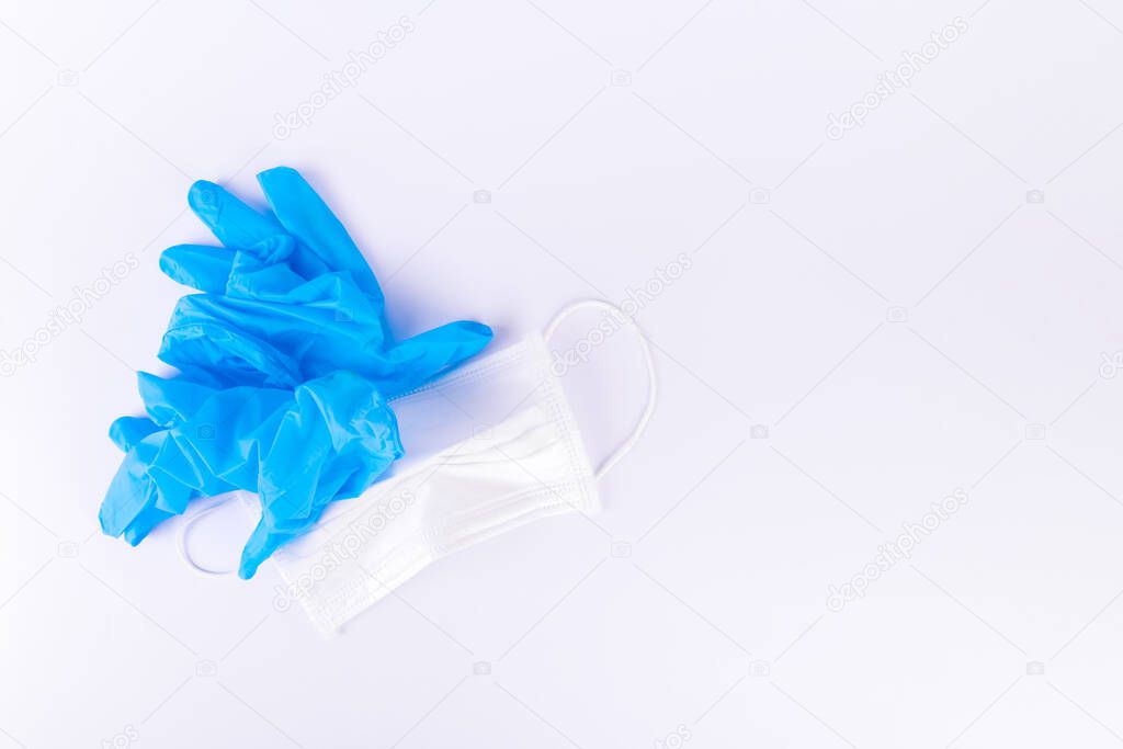 Crumpled used gloves and medical mask. Quarantine is over, victory over the coronavirus pandemic COVID-19, copy space