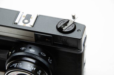 Eski film kamerası. Beyaz arka planda nadir bulunan bir kamera. İlham perilerinin elinde bir kamera. Sovyet fotoğraf ekipmanları. Makro kamera, lens, içerisi, detaylar. 