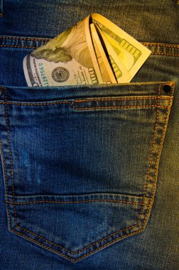Kot pantolonun cebinde Amerikan banknotları. 100 dolarlık banknotlar halinde bir not, arkadan sarkıyor, en önde gelen pantolon cebi. Para cebimden çıkar. Fişek etkisi. Farklı açılardan görüntüle