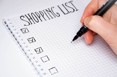 Alışveriş listesi. Elin kalem tutsun. Beyaz arka planda siyah kalemli kare şeklinde bir defter. Fikirleri, notları, planları, görevleri kaydet. Listede ekmek, süt ve muz yer alıyor..