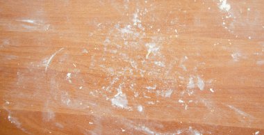 Un masanın üstünde. Masada küçük hamur parçaları var. Kokain gibi un.