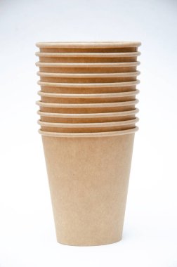 Brown paper cup for coffee, tea, a drink from environmental materials on a white background. Many cups in a one-on-one ass. A row of glasses up. Wide glasses, buckets