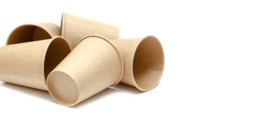 Kahve, çay için kahverengi kağıt bardak, beyaz arka planda çevresel malzemelerden bir içecek. Bir sürü bardak. Gözlükler bir halka şeklinde daire şeklinde yan yatar. Ön ve üst manzara. Makro, boş bardaklar