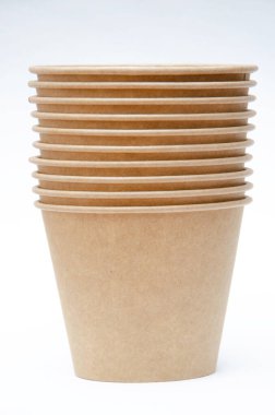 Brown paper cup for coffee, tea, a drink from environmental materials on a white background. Many cups in a one-on-one ass. A row of glasses up. Wide glasses, buckets