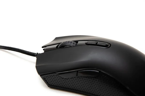 Black gaming mouse with side extra keys and a matte finish on white background. Mouse side view in macro and general plan. Lateral rubber inserts against sliding, pimples. Left and right mouse