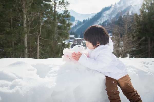 Little boy with snowman — Stock Photo, Image