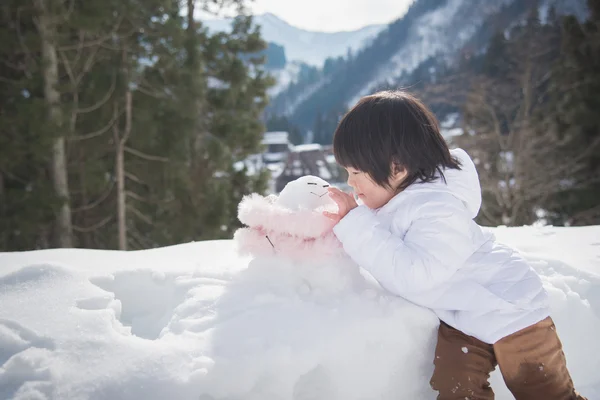 Little boy with snowman — Stock Photo, Image