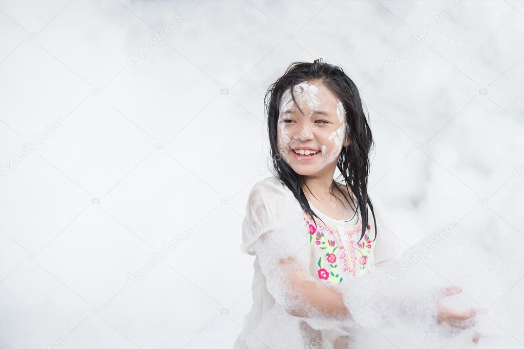 asian girl smiling in foam party