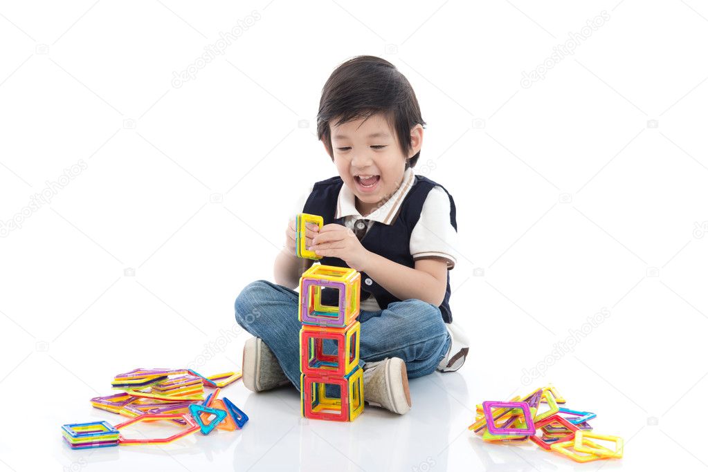 child playing with lots of colorful plastic blocks kit