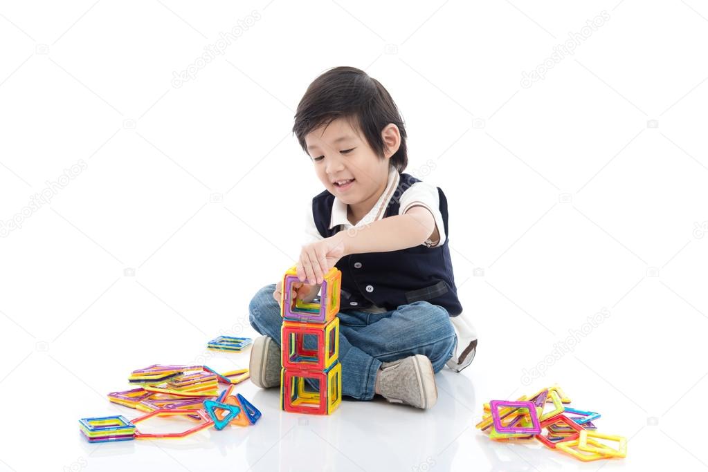 child playing with lots of colorful plastic blocks kit