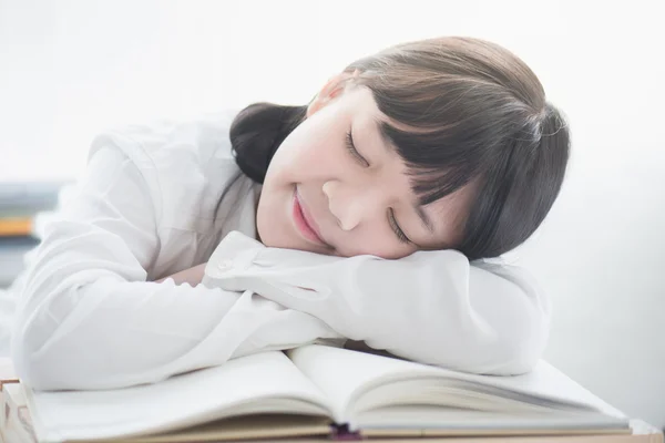 Όμορφο κορίτσι της Ασίας στον ύπνο για τα βιβλία — Φωτογραφία Αρχείου