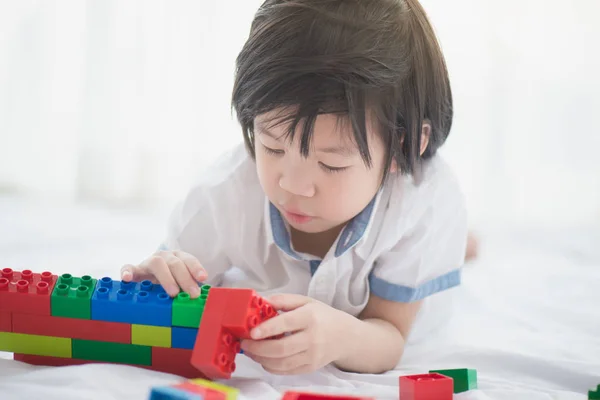 Asiático niño jugando con colorido construcción bloques —  Fotos de Stock