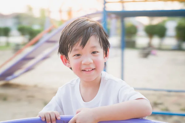 Asian child having fun on carousel — Stock Photo, Image