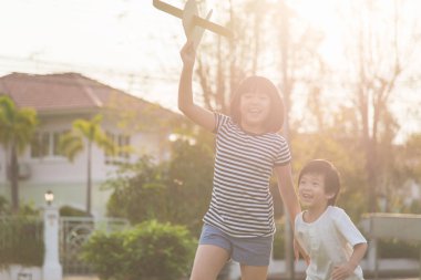 Şirin Asyalı çocuk karton uçak oyun