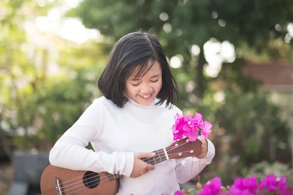 Asian girl playing ukulele, Outdoor portrait — Stock Photo, Image