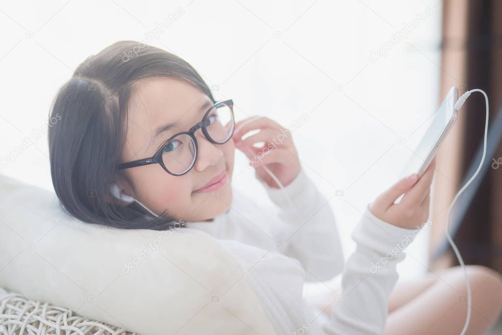 Asian girl using earphone for listen music
