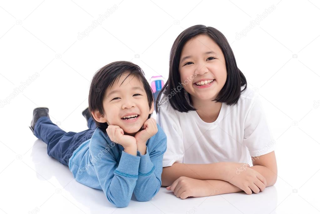 Asian children lying on white background isolated