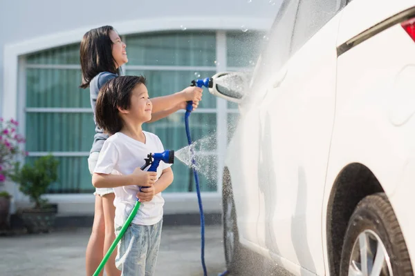 Asian children washing car