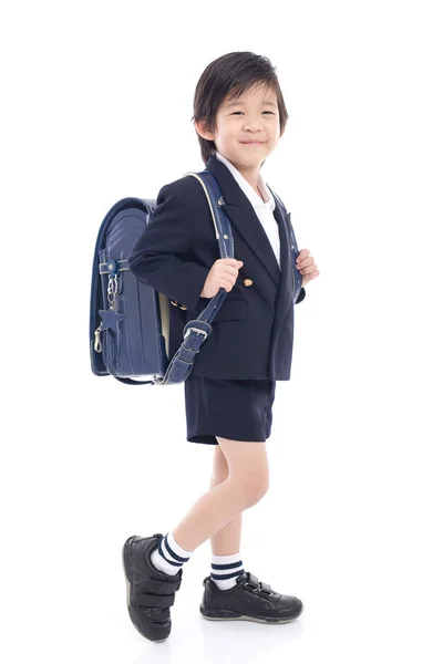 Criança asiática em uniforme escolar com saco de escola azul — Fotografia de Stock