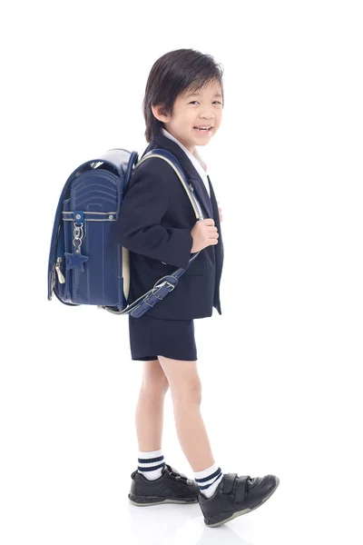 Criança asiática em uniforme escolar com saco de escola azul — Fotografia de Stock