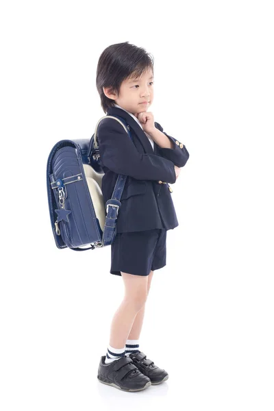 Criança asiática em uniforme escolar com saco de escola azul — Fotografia de Stock