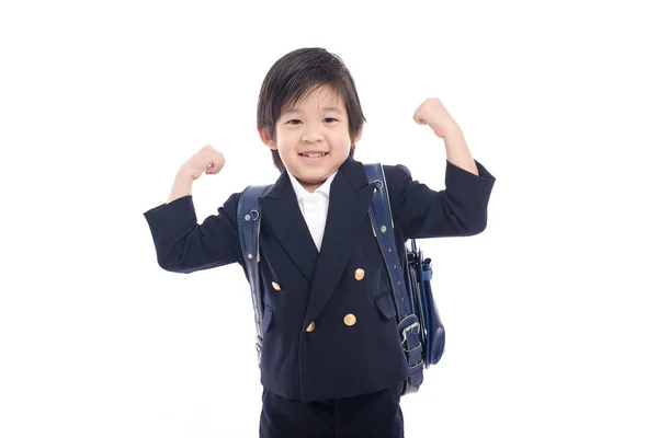 Asijské dítě ve školní uniformě s modrou školní batoh — Stock fotografie