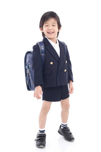 Niño asiático en uniforme escolar con bolso escolar azul —  Fotos de Stock