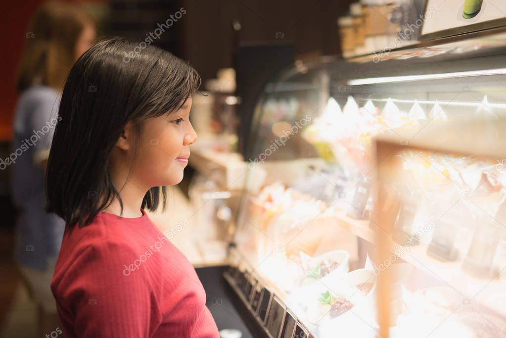 Asian girl choosing ice-cream
