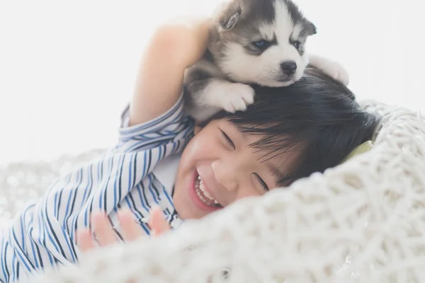 Bonito ásia criança jogar com siberiano husky cachorrinho — Fotografia de Stock