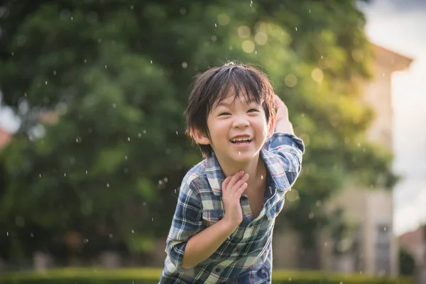 雨の中公園でパイロット パイロットを遊ぶかわいいアジアの子 — ストック写真