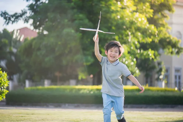 かわいいアジアの子公園屋外あなたにダン ボール飛行機を再生 — ストック写真