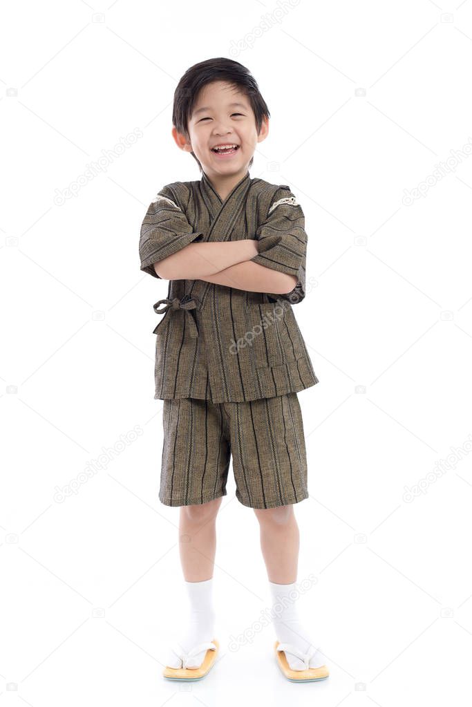 Happy asian boy in kimono on white background isolated