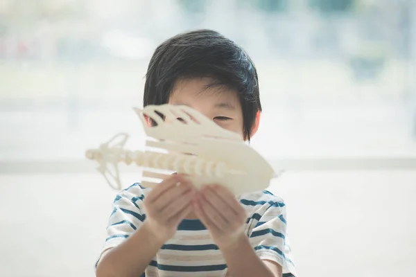 Asian child  builds a toy of wood — Stock Photo, Image