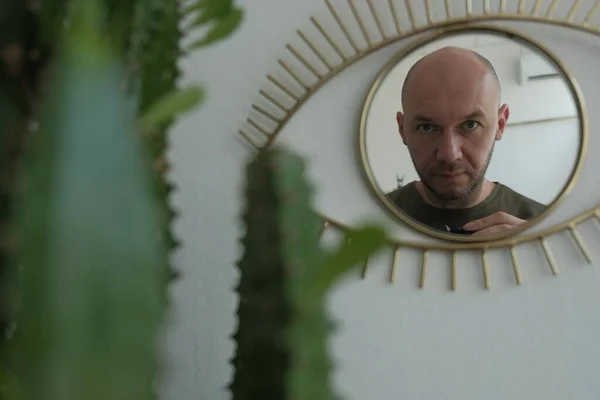 The bald Guy in the mirror, shoots himself. Selfie guy