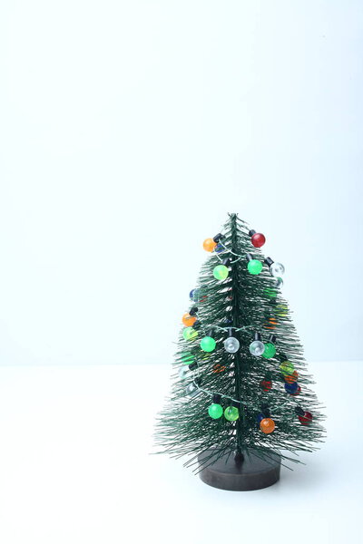 decorated fake Christmas tree isolated on white background