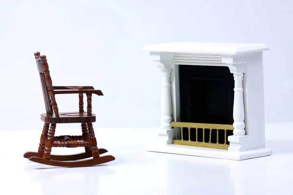 Интерьер кукольного дома - кресло-качалка рядом с камином изолировано на белом фоне — стоковое фото