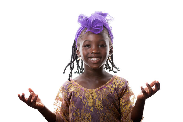 Beautiful portrait of a happy African little girl smiling with open arms in purple costume on white background