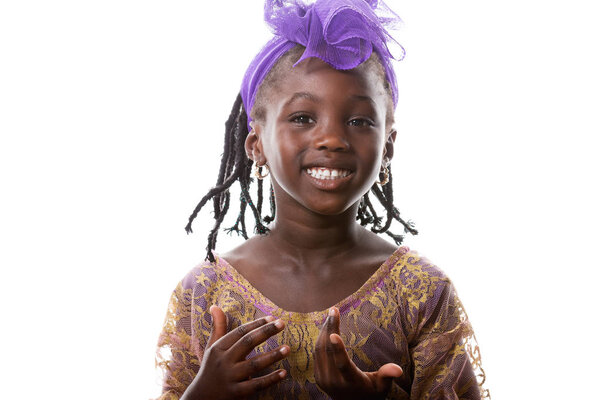 Beautiful portrait of a lovely African little girl in purple costume on white background