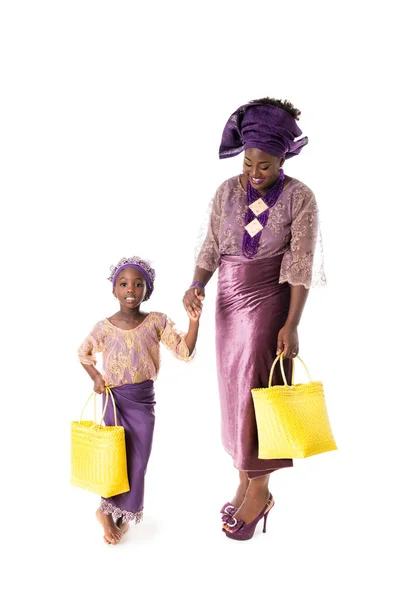 stock image African woman and little girl in traditional clothing with tote bags.Isolated
